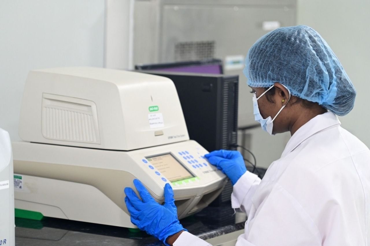 A scientist operating a real-time PCR system