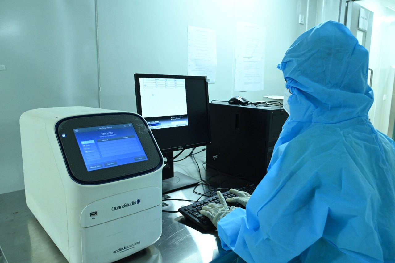 Technician running an assay on a QuantStudio system